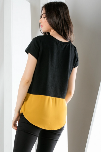 Back view of short sleeve black top with gold contrast hem. Rounded hem with good length for bum coverage.