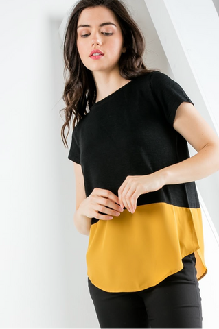 Women's short sleeve top with contrast hem in black and gold.
