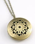 Vintage style locket in round brass filigree.