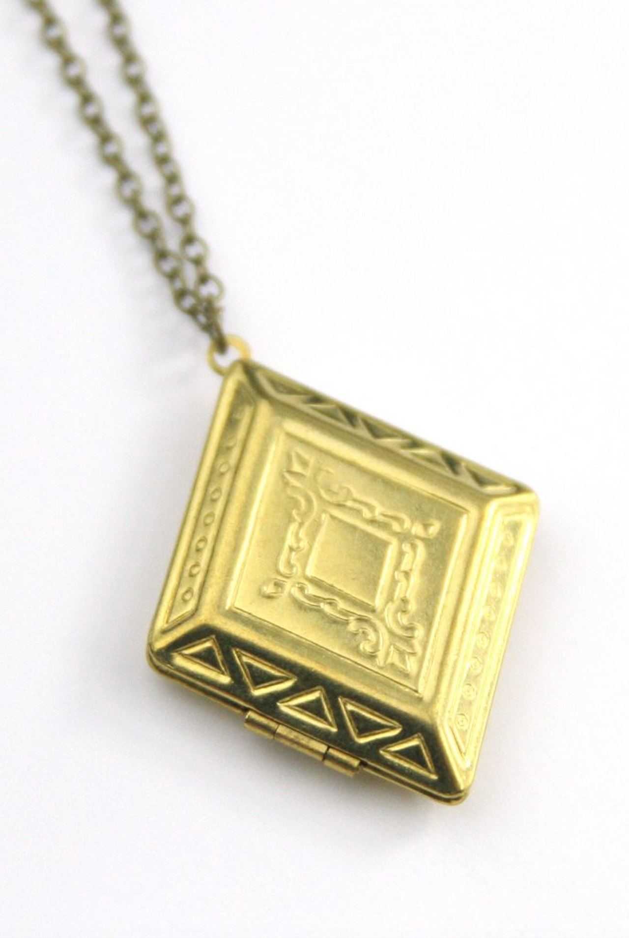 Vintage diamond shaped locket with beautiful imprinted design.