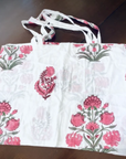 Reusable grocery bags foldable. White and pink floral print.