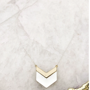 Mixed metal chevron pendant necklace. Top chevron bar is gold and thinner above thicker silver chevron bar on pendant.