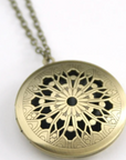 Vintage style locket in round brass filigree.