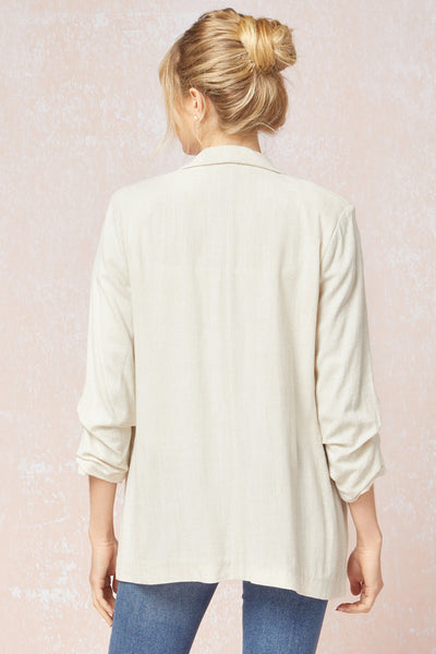 Back view of Women's white blazer with scrunched sleeves. Natural linen color. Summer blazer.