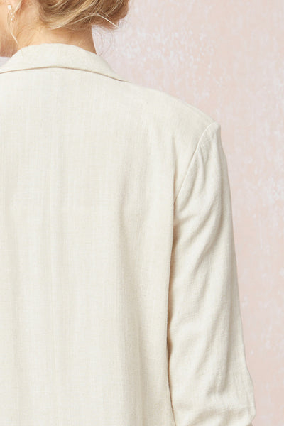 Close up of back of Women's white blazer with scrunched sleeves. Natural linen color. Summer blazer.