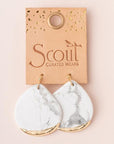 Large stone earrings dipped in gold on leather display card.