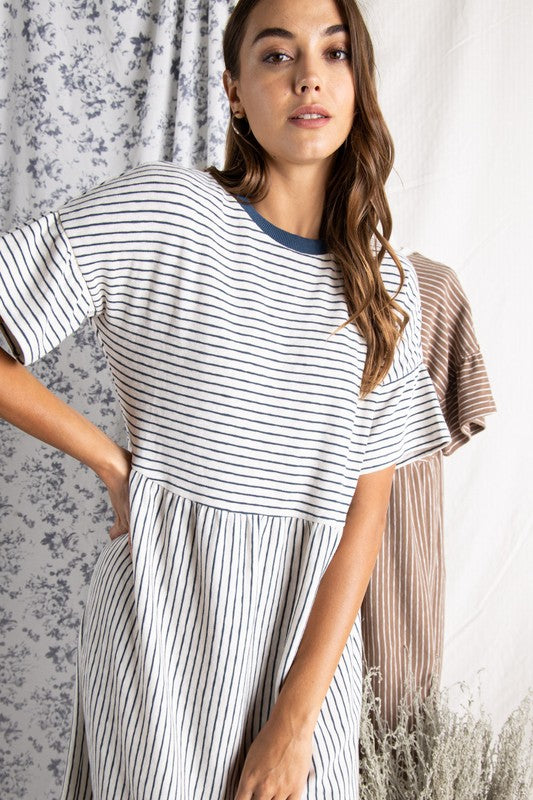 Close up of Women&#39;s cotton dresses. Striped Ivory and blue knit dress with wide short sleeve.