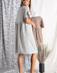 Back view of Women's cotton dresses. Striped Ivory and blue knit dress with wide short sleeve.