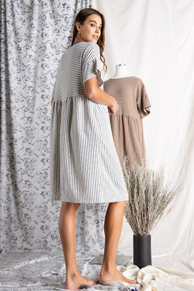 Back view of Women's cotton dresses. Striped Ivory and blue knit dress with wide short sleeve.