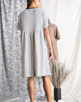 Back view of loose fit Women's cotton dresses. Striped Ivory and blue knit dress with wide short sleeve.