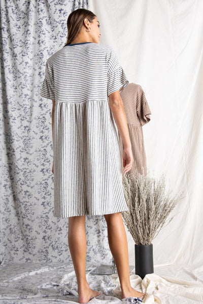 Back view of loose fit Women's cotton dresses. Striped Ivory and blue knit dress with wide short sleeve.
