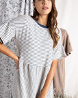 Close up of Women's cotton dresses. Striped Ivory and blue knit dress with wide short sleeve.