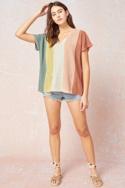 Women's linen top. Colorblock vertical stripes with v-neck and short sleeves. Paired with denim shorts and gladiator sandals.