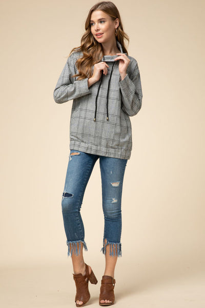 Black plaid cowl neck pullover paired with distressed skinny jeans.