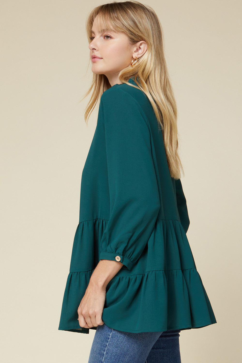 Side view of 3/4 sleeve teal women's button up tiered tunic. Great coverage.