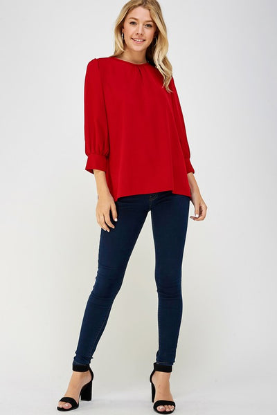 Cute women's 3/4 sleeve top with cuffs in red shown with skinny jeans.