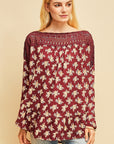 Long sleeve boho top with crocheted neckline in burgundy floral pattern.