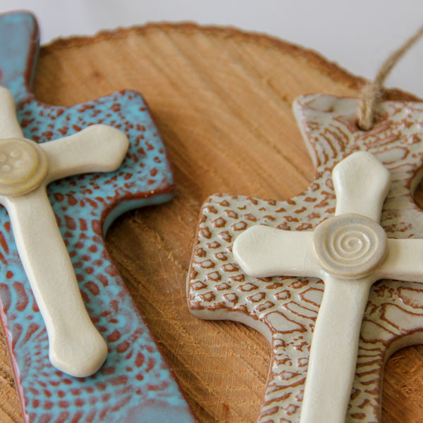 Close up of trinity hanging cross. Handmade hanging cross gift.