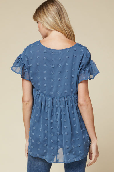 Back view of women's lightweight top - blue v-neck with ruffle sleeve