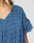 close up of front of women's plus size babydoll top - blue dot