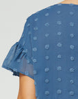 close up of back of women's plus size babydoll top - blue dot