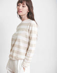 Side view of ultra-lightweight linen tan and white striped sweater.