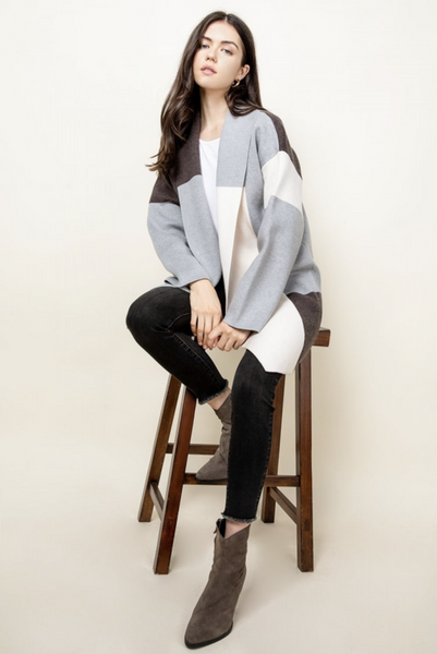 Womens bell sleeve cardigan worn by model with black jeans.
