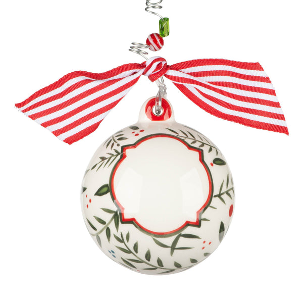 Customizable Christmas ornament with names. Front has holly design and space for personalization. Pretty red ribbon on wire beaded hook.