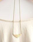 Art deco necklace gold on chain.