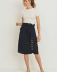 Belted paperbag waist skirt worn by model with white tee.