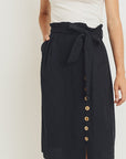 Close up of belted paperbag waist skirt.