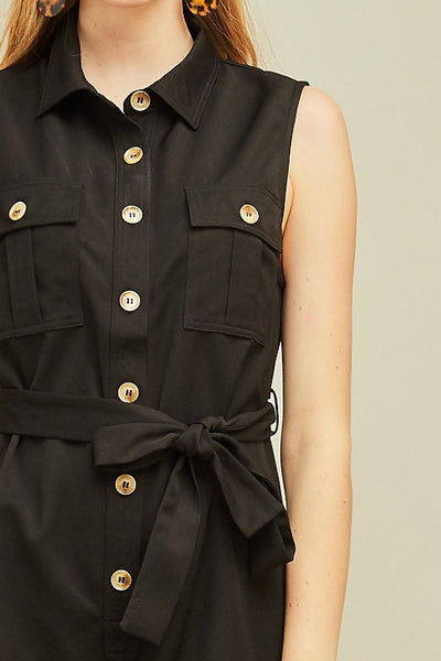 Black shorts romper outfit. Close up of buttons and chest pockets.
