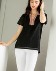 Embroidered black top. Paired with white denim.