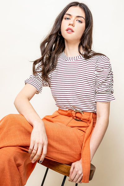 Woman's tee with striped print and ruched short sleeves.