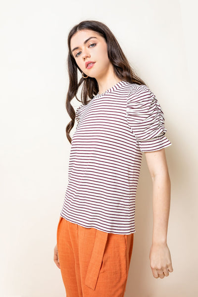 Woman's short sleeved tee with ruched sleeves.