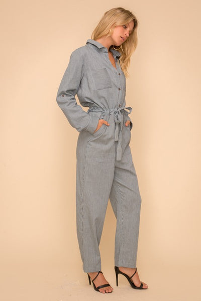 Women's striped coveralls with pockets and tie waist.