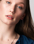 Unique lightweight hoop earrings worn by model.