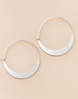 Lightweight hoop earrings in silver crescent shape.