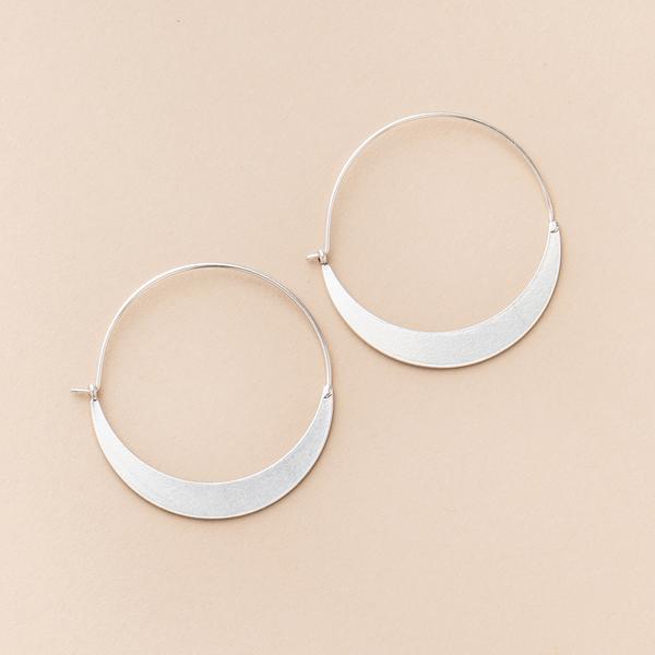 Lightweight hoop earrings in silver crescent shape.