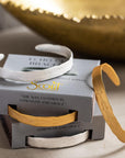 Engraved bracelets for women. Stacks of gold and silver bracelets with sound wave etched on outer edge meaning "Live in the sunshine. Swim in the sea. Drink the wild air."