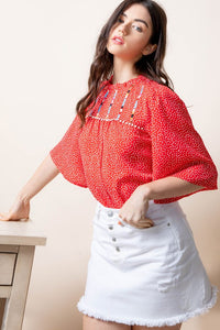 Embroidered bell sleeve blouse.