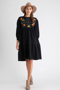 Women's bohemian style dresses with embroidery. Black with floral detail on chest and midi length.