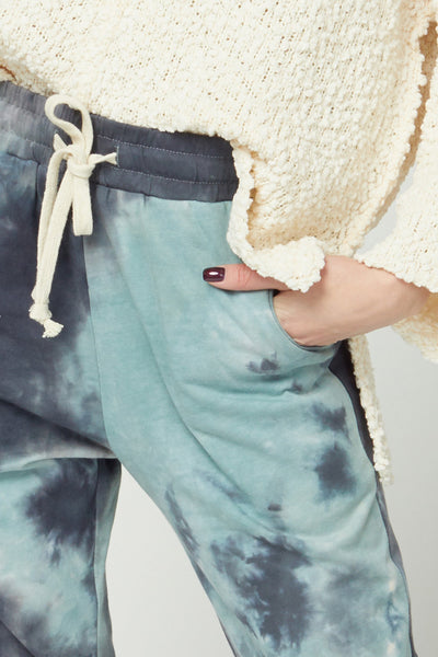Close up view of lightweight tie dye joggers drawstring waistband and pockets.