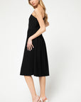 Side view of One shoulder, fit and flare knit little black dress in midi length.