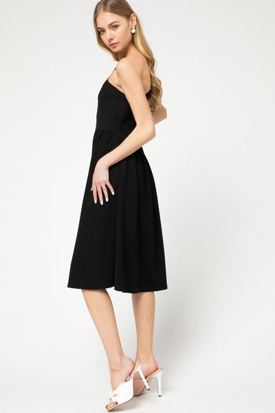 Side view of One shoulder, fit and flare knit little black dress in midi length.