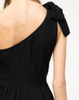 Close up of back view of bodice on one shoulder little black dress.