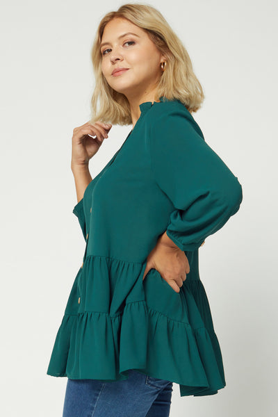 Side view of plus size 3/4 sleeve tiered tunic with loose fit and good coverage.