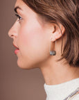 Natural stone drop earrings worn by model.