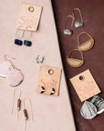 Natural stone drop earrings on display with other Scout earring styles.