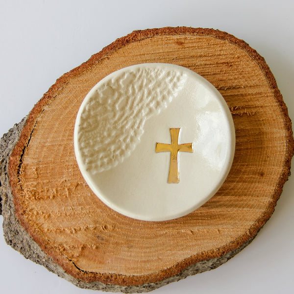 Handmade ring dish gift. White with gold cross sitting on wood stump.